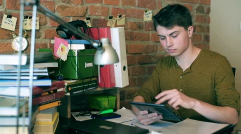 Student working on tablet and smiling to the camera 스톡 동영상 40928406