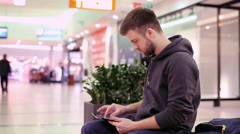 Student Working on a Tablet in Shopping Center Stock Footage 47977461