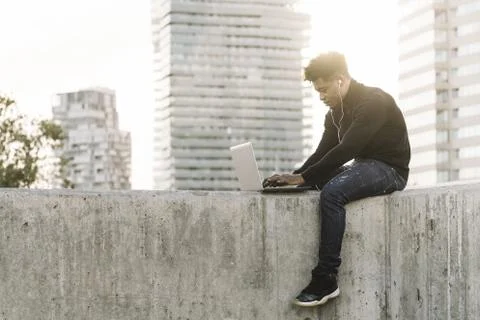 Student working typing in a computer at the city Stock Photos