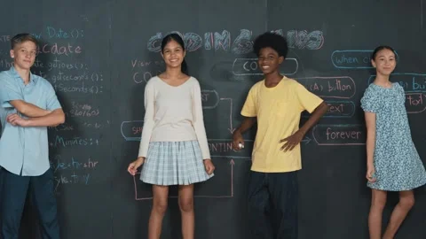 Student write code on blackboard and turn around to pose at camera. Edification Video stock 263716970