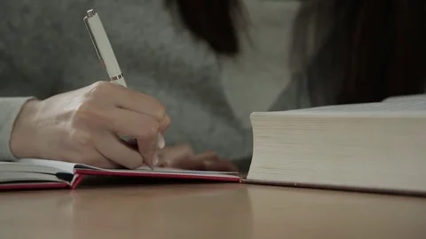 Student writes in the exercise book Stock Footage 73365254