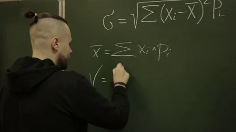 Student writes a formula on the blackboard Stock Footage 73365258
