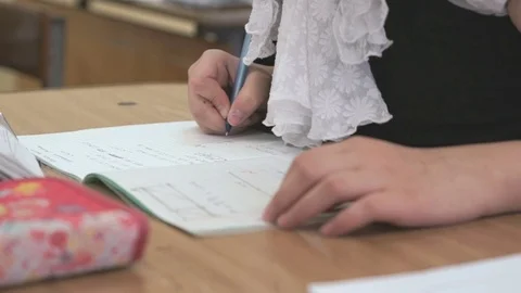Student writes text in a notebook on a lesson Stock Footage 71605020