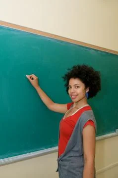 Student writing on blackboard Stock Photos