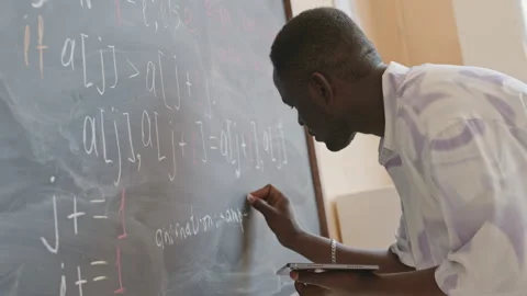 Student Writing Computer Algorithm on Chalkboard Stock Footage 257063319