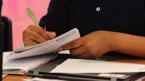 Student writing info on worksheet Stock Footage 92495491