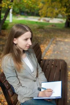 Student writing in notebook and thinking Stock Photos