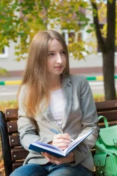 Student writing in notebook Stock Photos