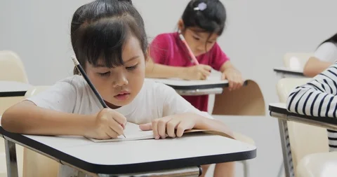 Student writing in notebooks in the classroom. Stock Footage 111404715