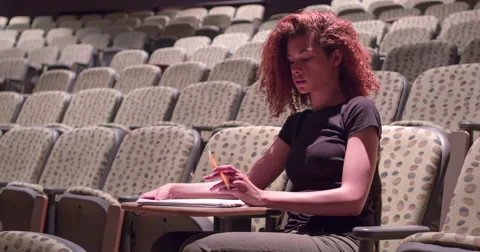 Student writing in notepad sitting alone in classroom 4k 스톡 동영상 50362277