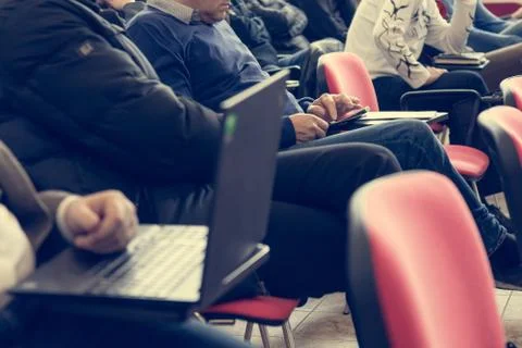 Student writing notes during conference training session. Stock Photos