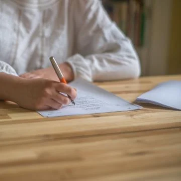 Student Writing Out School Work at Home Stock Photos
