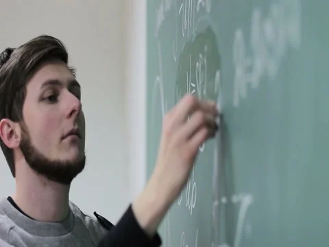 Student writing something on the blackboard Stock Footage 83431479
