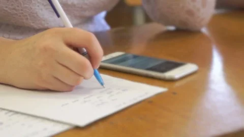 Student writing text in exercise book. Close-up Stock Footage 78595742