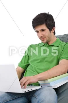 Student - young man with laptop sitting on bean bag Stock Photos