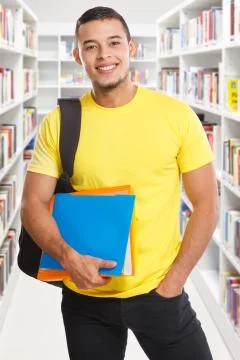 Student young man portrait format library learning smiling people Stock Photos