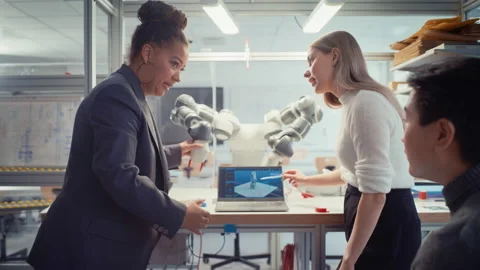 Students And Senior Engineer Use Programmable Robot Stock Footage 187559863