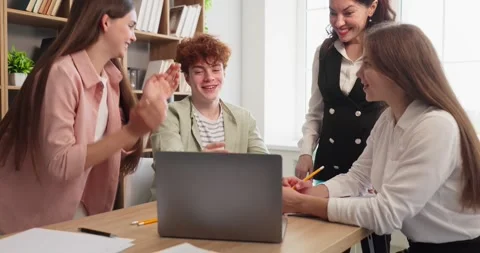Students and teacher applauding successful project in collaborative classroom Stock Footage 340560874