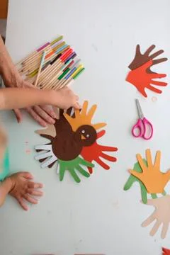 Students and teacher making Thanksgiving turkey crafts in classroom Stock Photos