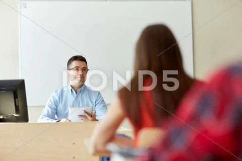 Students and teacher with tablet pc at school Stock Photos