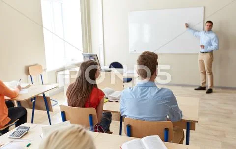 Students and teacher writing on school white board Stock Photos