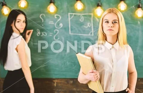 Students and trainees concept. Girl looks confident while lady writing on Stock Photos