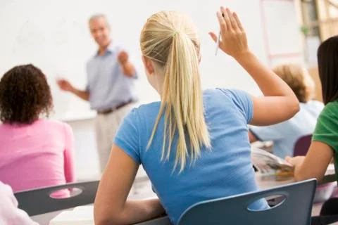 Students answering questions in math class with teacher Stock Photos