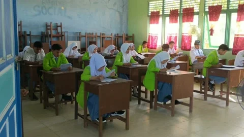 Students are filling out the width of the answers from the school exam questions Stock Footage 237043940