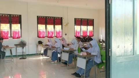 Students are filling out the width of the answers from the school exam questions Stock Footage 237043955