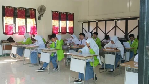 Students are filling out the width of the answers from the school exam questions Stock Footage 237043956