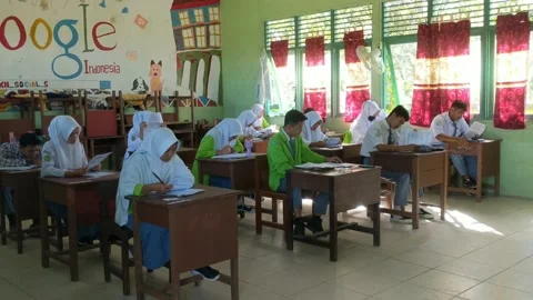 Students are filling out the width of the answers from the school exam questions Stock Footage 237043957