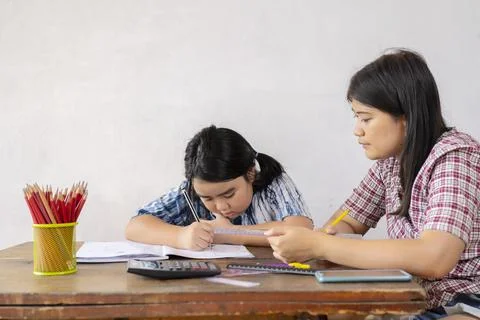 Students are solving mathematical problems. The teacher is teaching an Asian  Stock Photos
