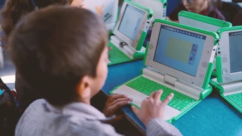 Students are using XO laptops in a classroom setting Technology education in Stock Footage 330873077