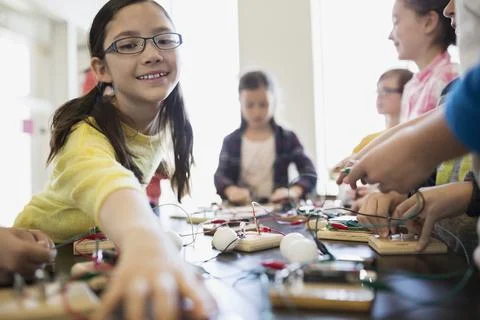 Students assembling circuit electronics at table Stock Photos