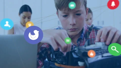Students assembling robotics kit at workbench in tech classroom, with floating Stock Footage 309111986