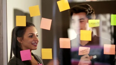 Students attack post-it on the window. Stock Footage 123122170