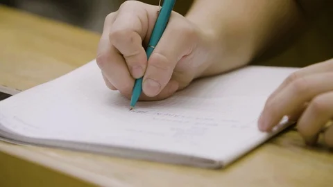 Students attending a class in the college lecture room take notes Stock Footage 116016711