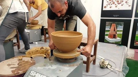 Students attending to the pottery contest at the symposium. Stock Footage 104076657