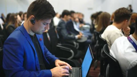 Students business forum type notebook lecture crowd audience college. Laptop man Stock Photos