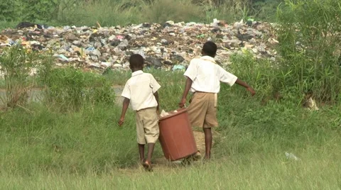 STUDENTS CARRYING FULL BIN TO TRASH HEAP Stock Footage 60626711