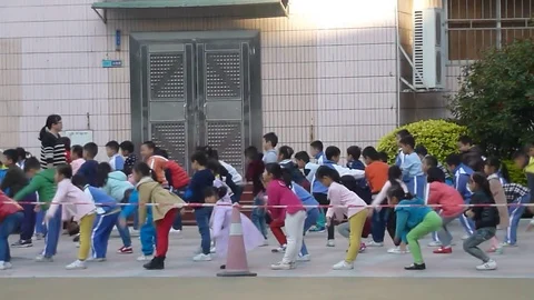 Students on the Chinese elementary school line up to the playground Stock Footage 70542963