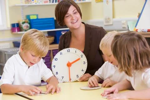Students in class learning how to tell time (selective focus) Foto stock