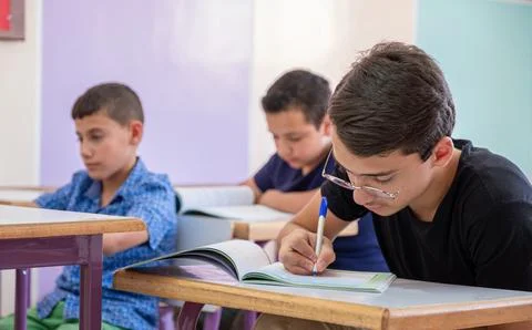Students in class room doing exercise Stock Photos