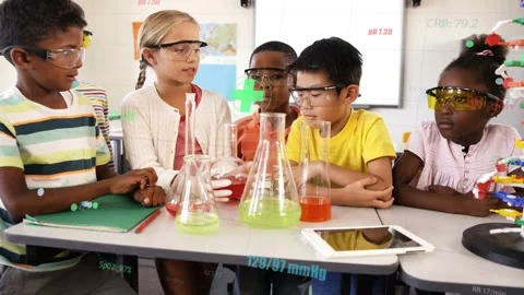 Students at class table girl holding red flask starting STEM checking flasks and Stock Footage 333803610