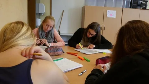 Students in the classroom during a writing task. Stock Footage 69318404