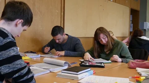 Students in the classroom during a writing task. Video stock 69322484