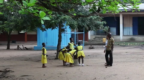 STUDENTS CLEANING SCHOOLYARD UNDER TEACHER SUPERVISION Stock Footage 60115480