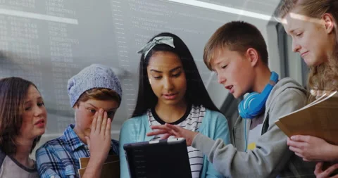 Students coding around tablet in modern education lab, showing translucent code Stock Footage 307429347