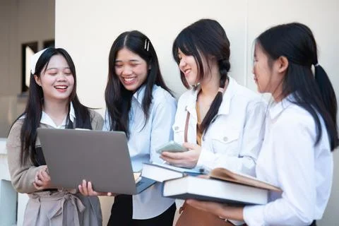 Students collaborating on laptop while studying together Stock Photos