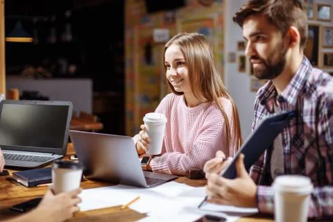 Students communicating at cafe after lesson. Stock Photos